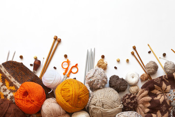 Tangles of orange, brown and beige wool yarn for hand knitting, accessories for knit, and knitted...
