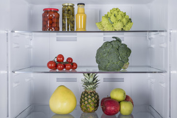 Open fridge full of fresh fruits and vegetables