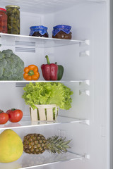 Open fridge full of fresh fruits and vegetables