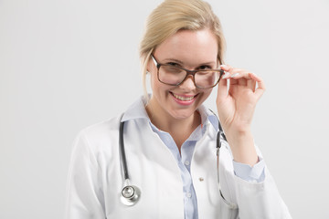 frienly looking female family doctor in doctor's overall with stethoscope
