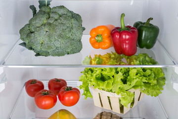 Open fridge full of fresh fruits and vegetables
