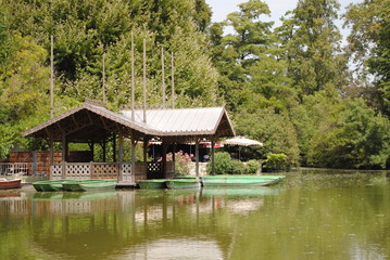 Fototapeta na wymiar House in a pond with boats