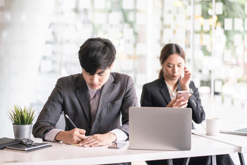 Portrait of casual young  entrepreneur businessman working in modern work station.