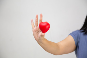 Pregnant women holding red hearts, Concept: Family expectations Happy lifestyle,mother in dress holds hands on belly,