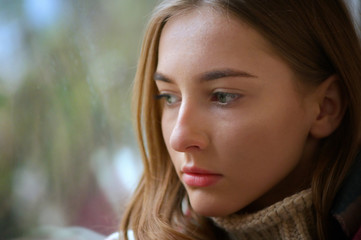 Naklejka premium Woman Sitting By The Window
