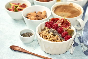 oatmeal with raspberries, figs, chia seeds and nuts for breakfast