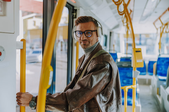 Handsome stylish man standing inside the tram