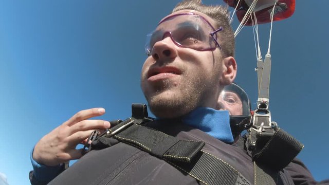 Footage of two skydiver falling the free fall and their parachute opens