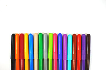 Fototapeta premium multi-colored felt-tip pens on a white sheet of paper. felt-tip pens on a white background