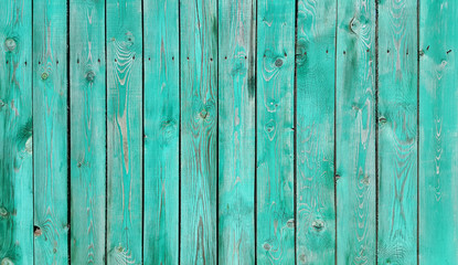 Texture of weathered wooden green painted fence