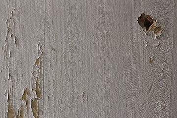 Wall with white paint peeling off
