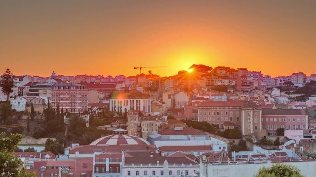 Sunrise over Lisbon aerial cityscape skyline timelapse from viewpoint of St. Peter of Alcantara, Portugal. Historical buildings from above at morning