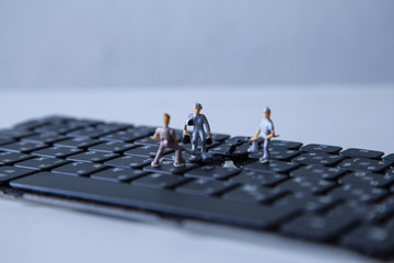 miniature people keyboard black repair, Concept: working in technical teams, technology systems, Behind the maintenance engineering, Computer Hardware Hardware for Laptops, closeup mini top view