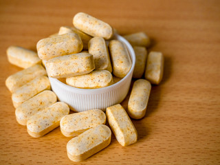 Pile of herbal pills spilled in bottle cap