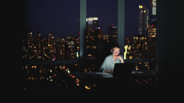 Tired professional manager finishing deadline job with project sitting at desktop in skyscraper office connected to 4g internet on laptop, business woman feeling headache from overtime