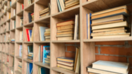 Book background. Blurred background with books on library shelves.