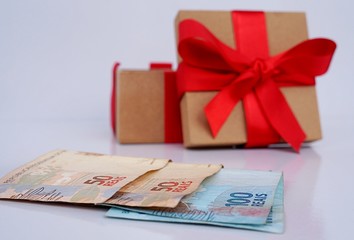 Brazilian Real banknotes and gift box. Brazilian money. Christmas concept. Money for Christmas.
