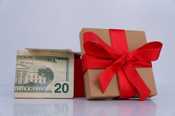 Opened Christmas gift box with USA dollar banknotes.