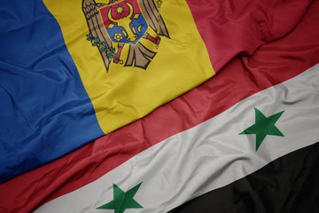 waving colorful flag of syria and national flag of moldova.