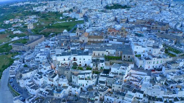 aerial view, flight at  at dusk, Mountain village, Ostuni, Apulia, Southern Italy