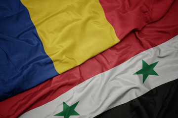 waving colorful flag of syria and national flag of romania.