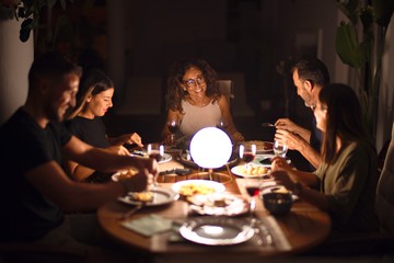 Beautiful family on dinner talking and smiling at terrace