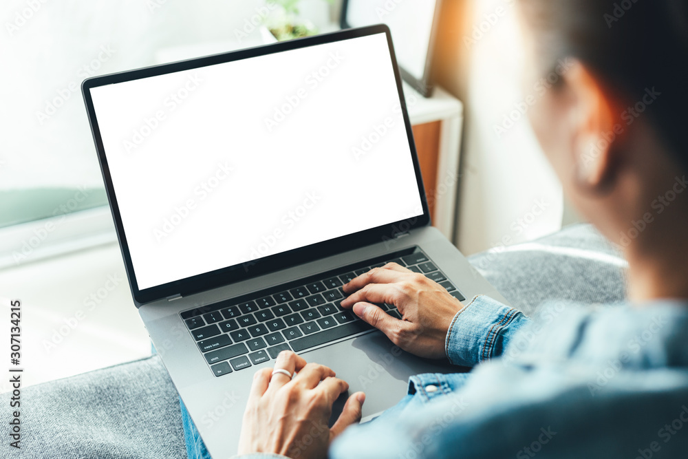 Wall mural mockup image blank screen computer with blank white background for advertising text,hand man using l