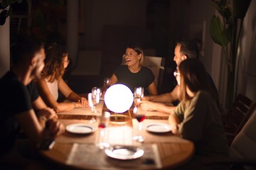 Beautiful family on dinner talking and smiling at terrace