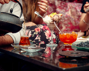 bowl with ice cream and a glass of hot tea