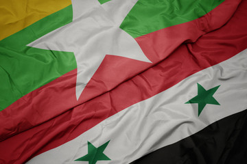 waving colorful flag of syria and national flag of myanmar.