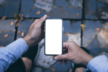 Mockup image blank white screen cell phone.men hand holding texting using mobile on desk at outdoor. background empty space for advertise text.people contact marketing business and technology 