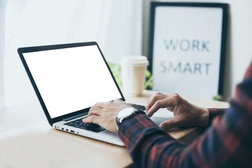 mockup image blank screen computer with blank white background for advertising text,hand man using laptop contact business search information on desk at home office.marketing and creative design