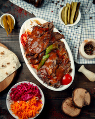 top view of iskender kebab garnished with tomato sauce