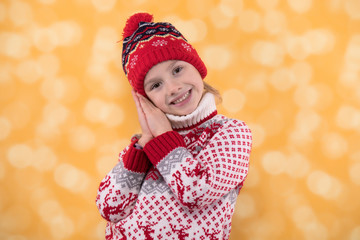 Little playful girl in winter look smiling