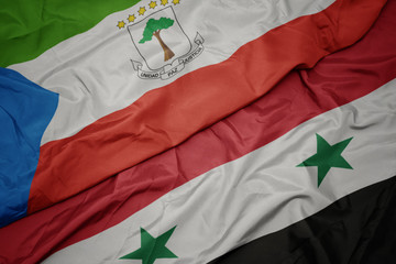 waving colorful flag of syria and national flag of equatorial guinea.