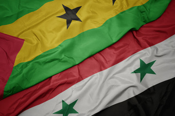 waving colorful flag of syria and national flag of sao tome and principe .