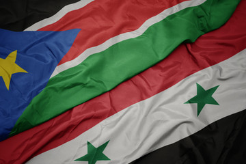 waving colorful flag of syria and national flag of south sudan.