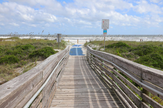 Blue roll out mat for handicapped beach access to Amelia Beach, Florida, USA.
