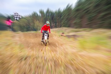   Motocross rider on a practice field . Front View Shot of the Professional Motocross .  Dirt Track. 