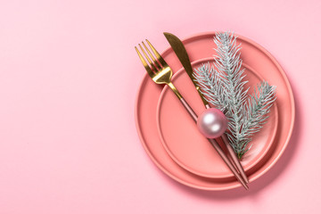 Christmas table setting on pink top view.