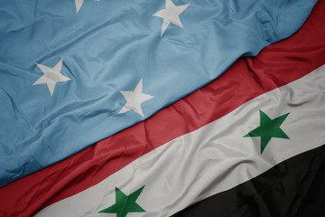 waving colorful flag of syria and national flag of Federated States of Micronesia .
