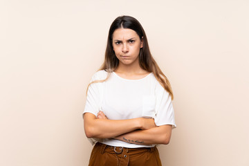 Obraz premium Young brunette woman over isolated background feeling upset