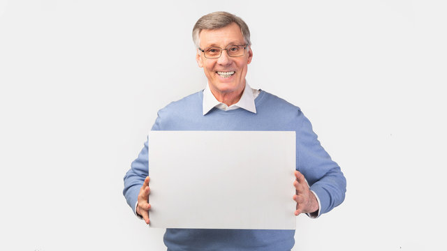 Elderly Man Holding Blank Board For Text Over White Background