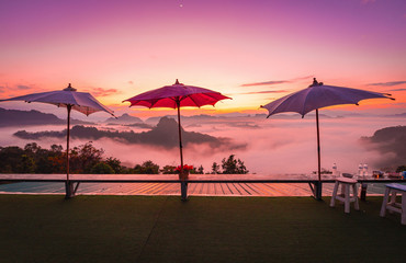 Big colorful umbrellas on resort terrace  with mountain view on the morning.