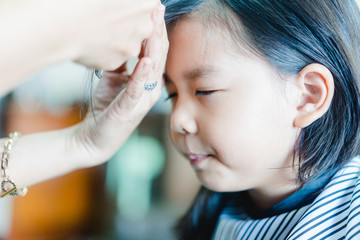 Obraz na płótnie Canvas Asian little girl haircut. hairdresser, beauty salon.Cute little asian girl in hairdressing salon.