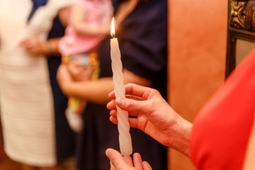 burning candle in women's hands