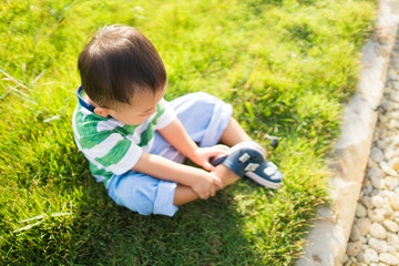 Little Asian toddler boy has allergies with mosquitoes and bug bite and itching his feet.He play in the playground park and Mosquito or snake bite in Rainy season.Mosquito sucking blood on child skin.