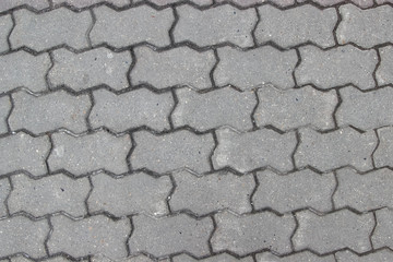 Sidewalk paved with geometric slabs as a background