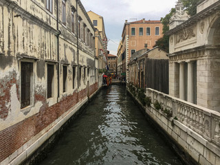 Fototapeta na wymiar Venice secondary canal lined with aging buildings