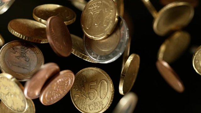 Euro coins falling from the sky along with Bitcoin. 4k, in 1000 fps, super slow motion.